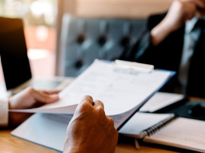 Lawyer reviewing paperwork in front of a colleague