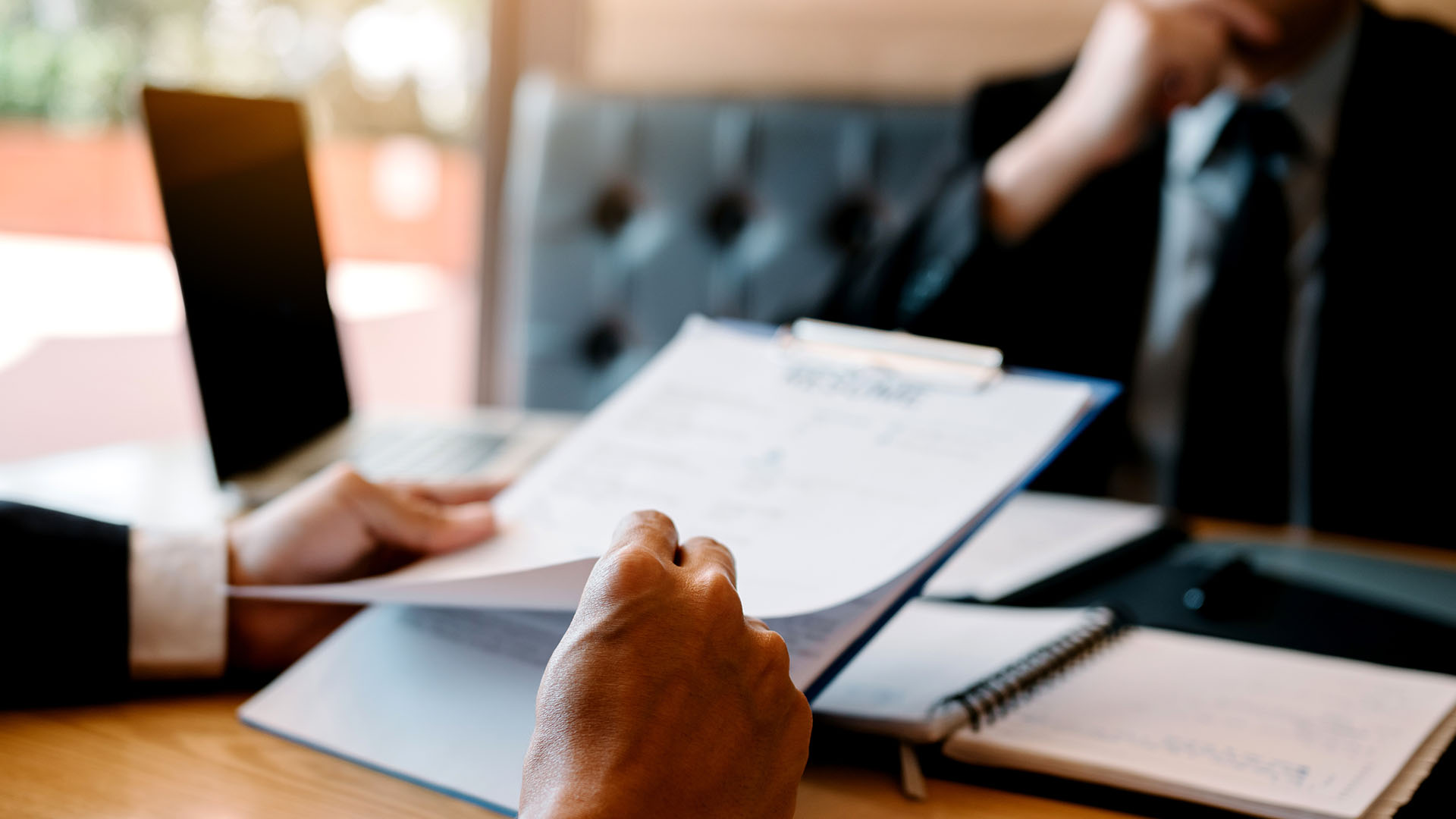 Lawyer reviewing paperwork in front of a colleague